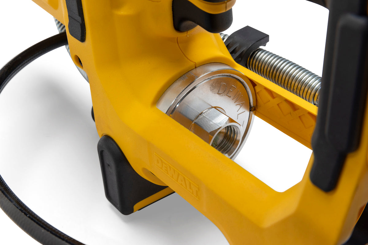 Closeup of DeWalt grease gun metal fitting and connector with yellow frame and black handle for lubrication use.