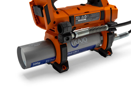 Side view of an orange cordless grease gun with a metal grease cartridge, black grip, and flexible hose for lubrication.